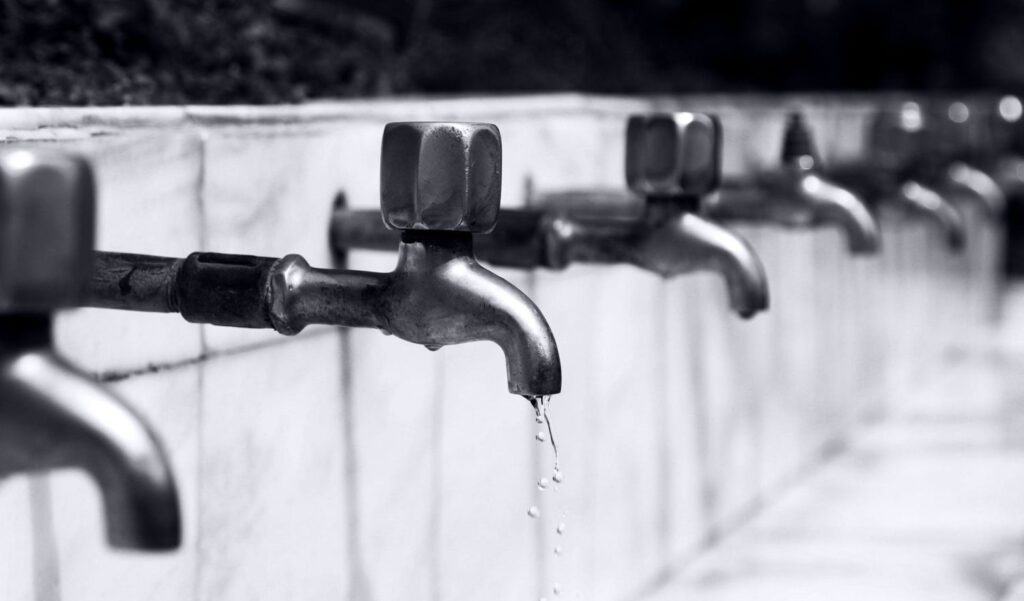 black and white photo of faucets